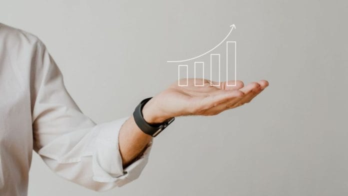 digital-increasing-bar-graph-with-businessman-hand-overlay-1-1024x576